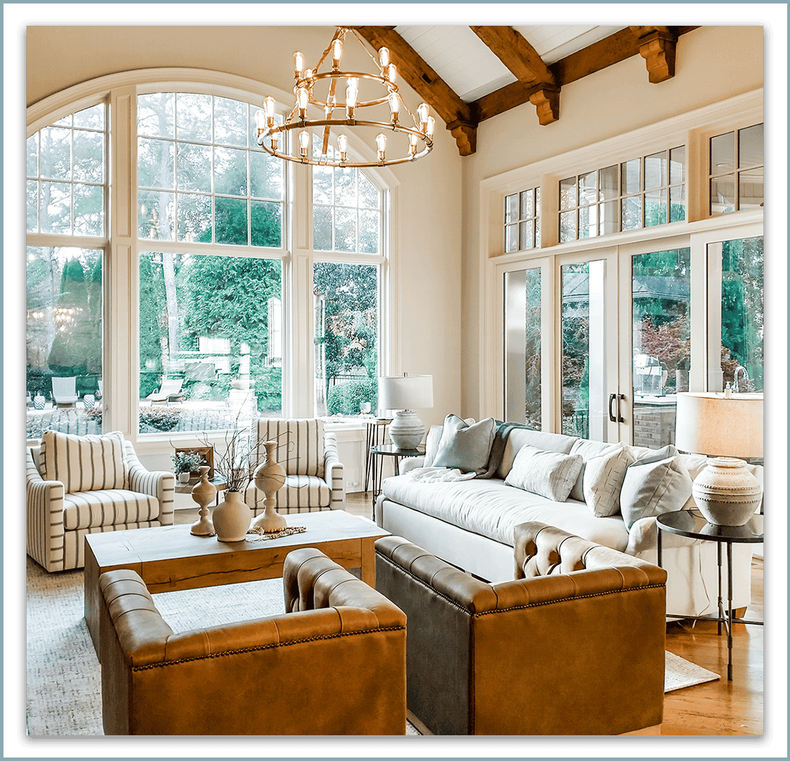 Spacious living room featuring large windows, cozy seating, and modern decor elements.