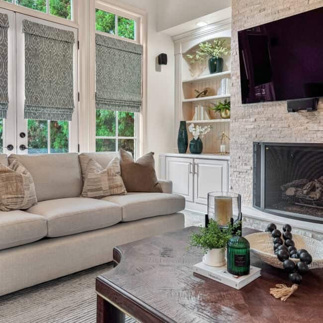 Bright living room with large windows and stylish decor elements.