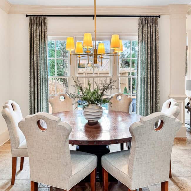 Bright, cozy dining area with six upholstered chairs and natural light.