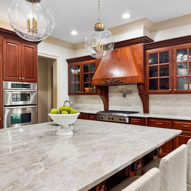 Bright kitchen with glass pendant lights and farmhouse style decor.