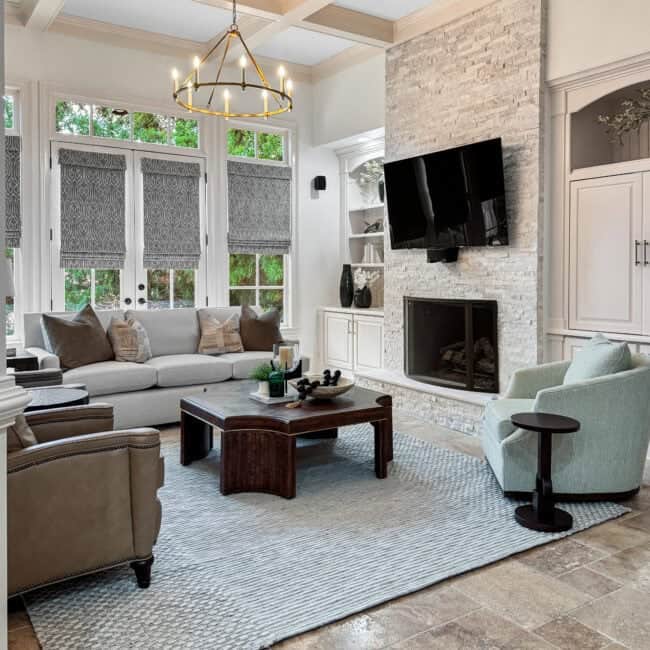Bright living room with fireplace, TV, and comfortable seating area.