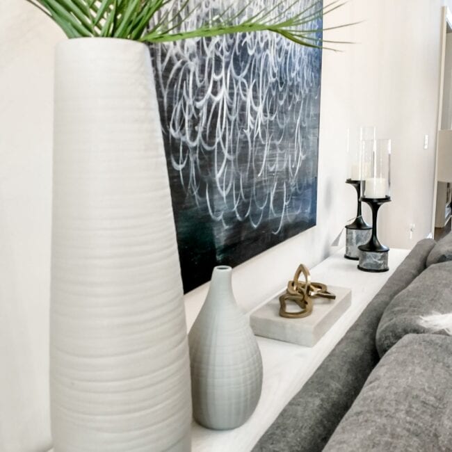 Stylish vases and contemporary artwork featured in modern interior design for sophisticated home decor.