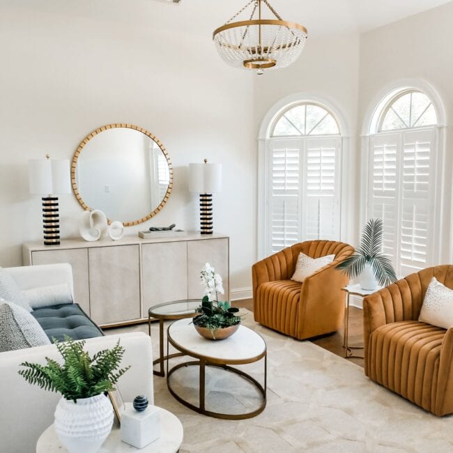 Bright, airy living space featuring contemporary furniture, natural light from arched windows, and stylish interior decor.