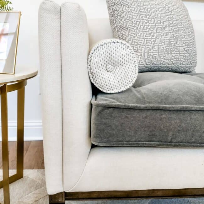 Elegant decorative pillows on a cozy grey sofa.