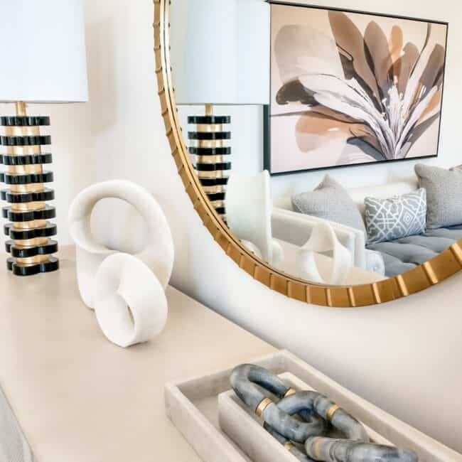 Elegant home interior with decorative sculptures, contemporary lighting, and a large wall art piece.