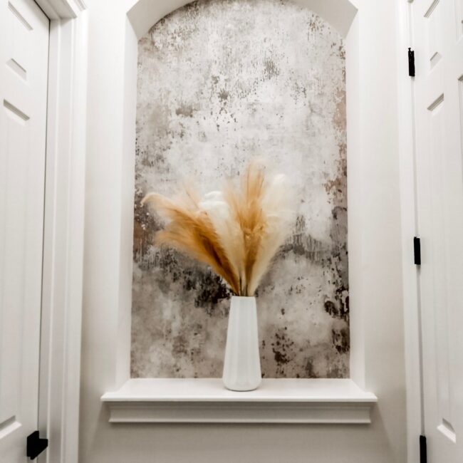 Elegant white vase with pampas grass in a modern interior display.