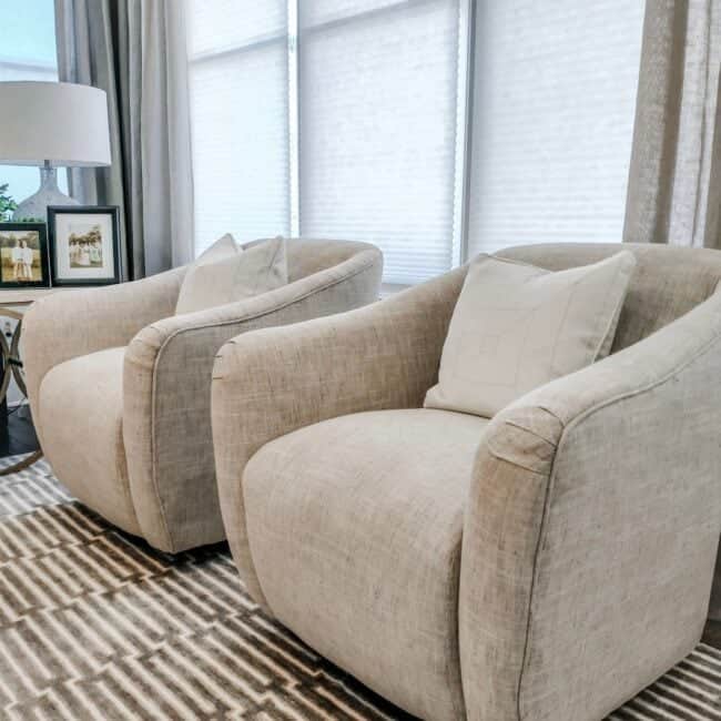 Comfortable beige armchairs with soft cushions, perfect for living room interior design.