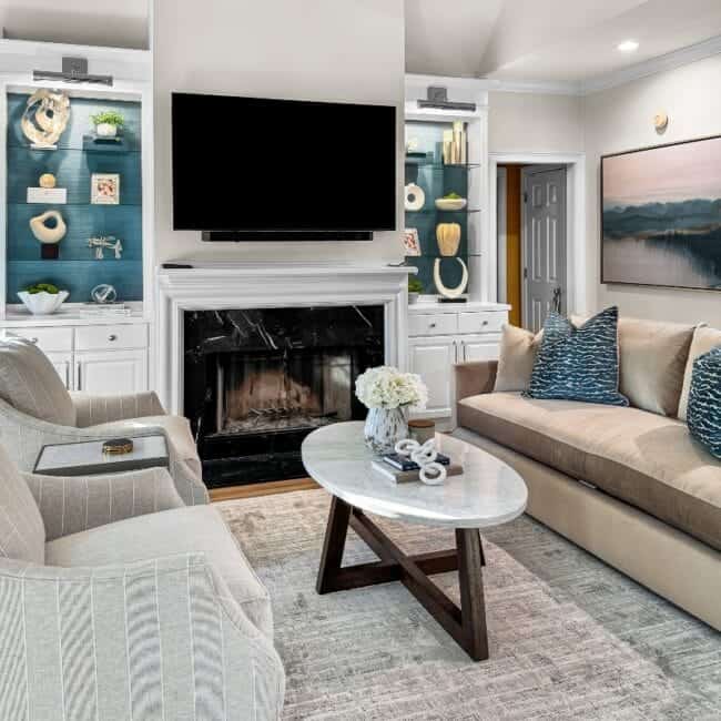 Bright, stylish living room with fireplace, flat-screen TV, and contemporary furnishings.