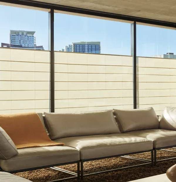 Spacious indoor lounge area with large floor-to-ceiling windows and stylish sofa setup.