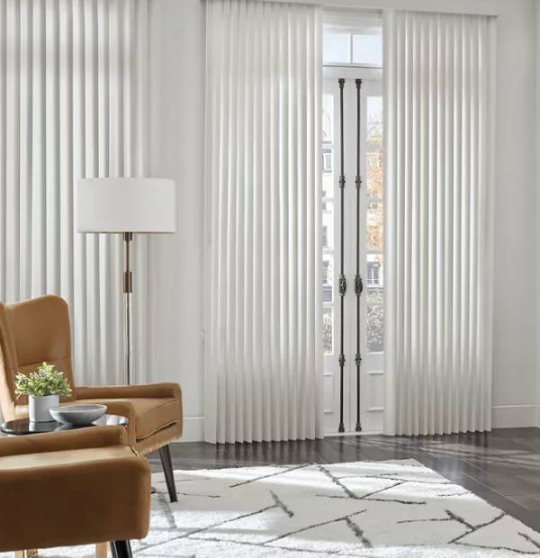 Vertical white blinds add modern style to living room.