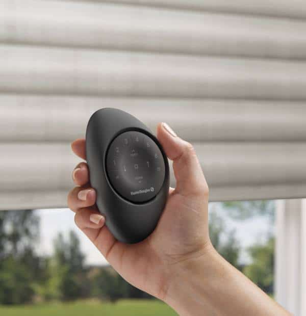 Remote control device for smart home automation with a sleek black design and touch control buttons.