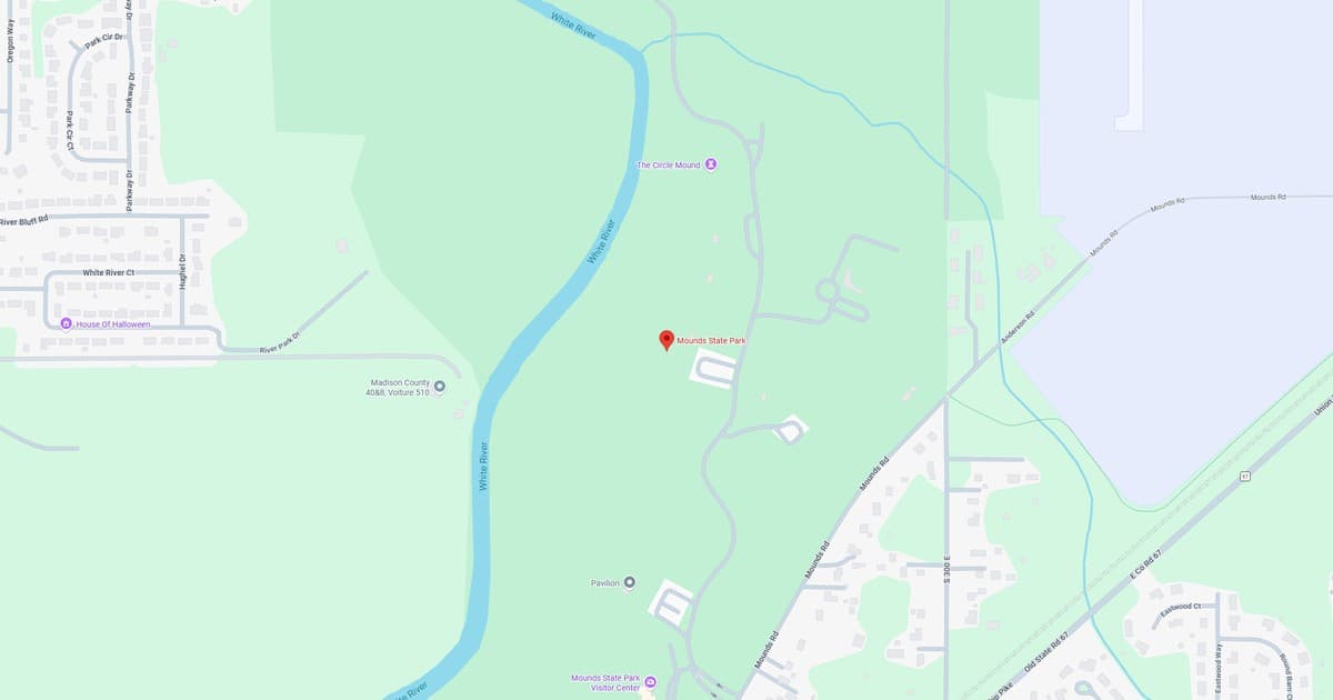 Map of a park showing river, trails, and surrounding areas in a natural setting.