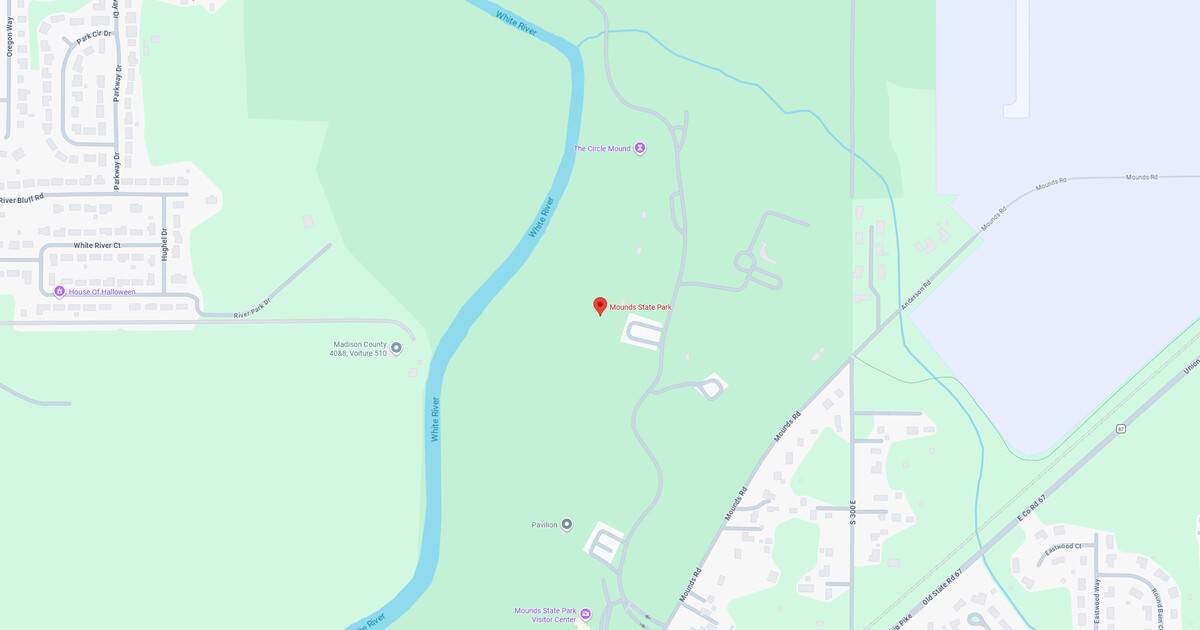 Map of a park with river, trails, and green spaces in a natural setting.