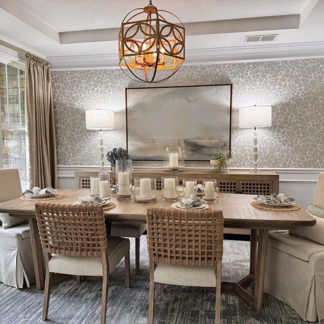 Stylish dining room with a large table, six chairs, and modern wall art.