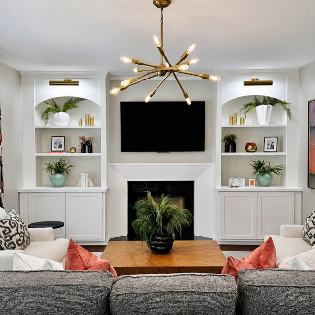 Contemporary living room with built-in shelves and a fireplace.