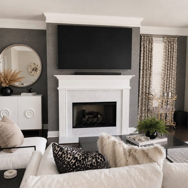 Contemporary living room with fireplace, wall-mounted TV, and stylish decor.