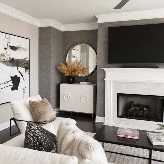 Contemporary living room with fireplace, wall art, and stylish decor elements.