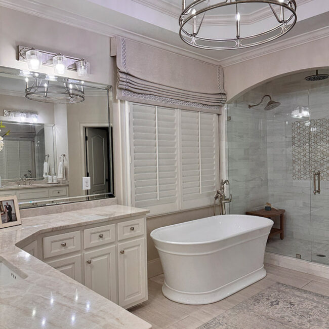 Modern bathroom with freestanding bathtub and glass shower enclosure.