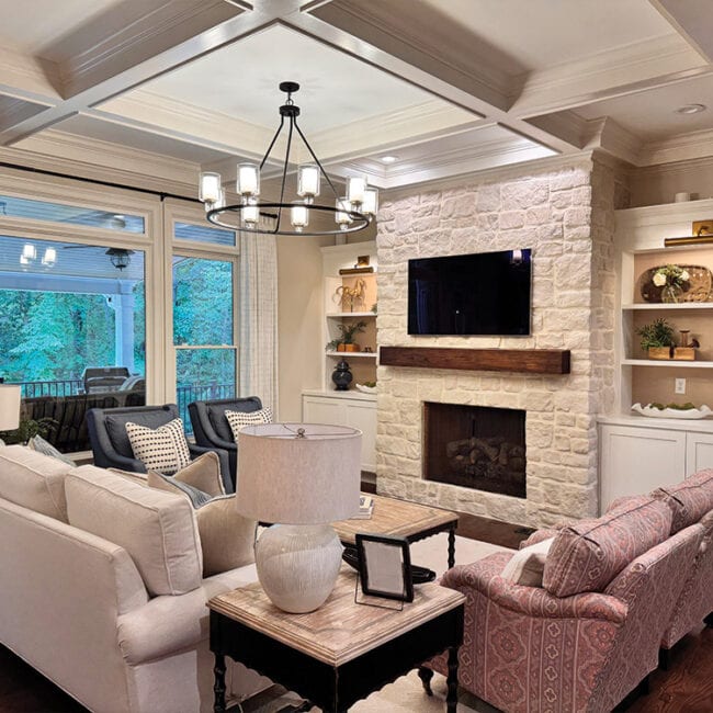 Bright living room with fireplace, large windows, and modern decor.